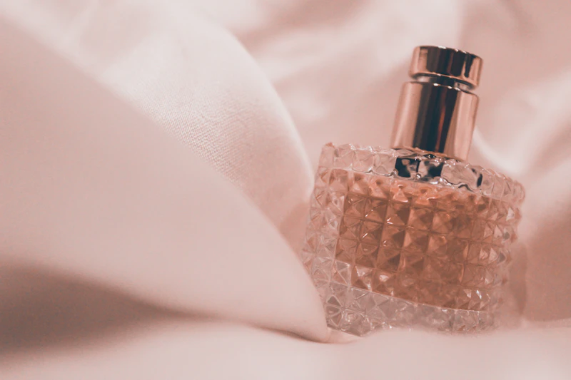Perfume bottle on pink fabric